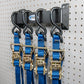 Four Tie Down Straps Hung on Pegboard Wall Mount