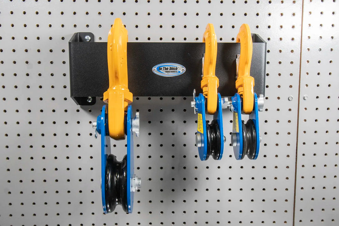 Multiple Size Snatch Blocks Hung on Pegboard