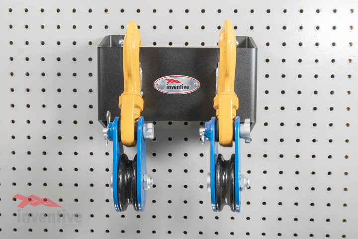 Two Snatch Blocks Mounted on Pegboard Wall