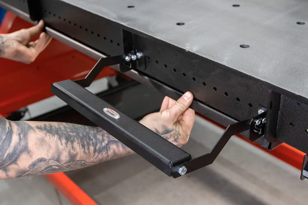 clamp holder pivots up and allows you to reach underneath weld table