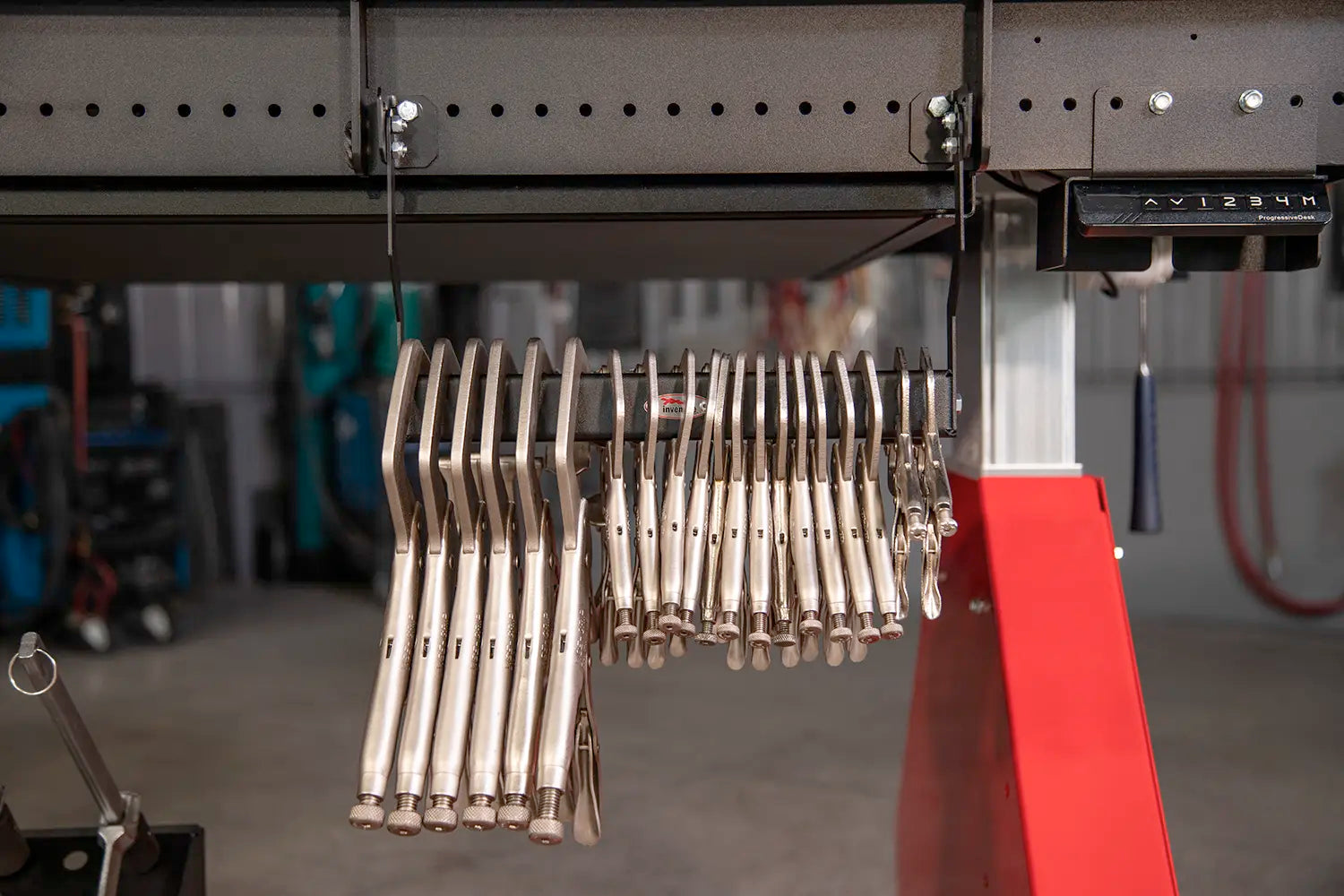 welding clamps hang below weld table