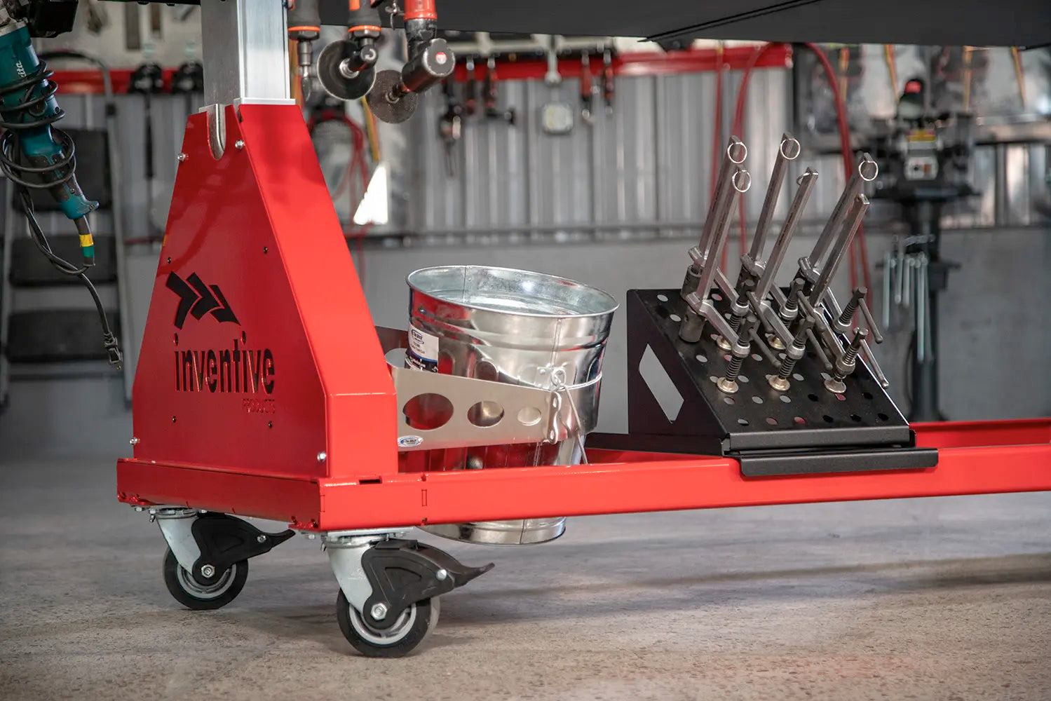 trash can and tools stored underneath welding table
