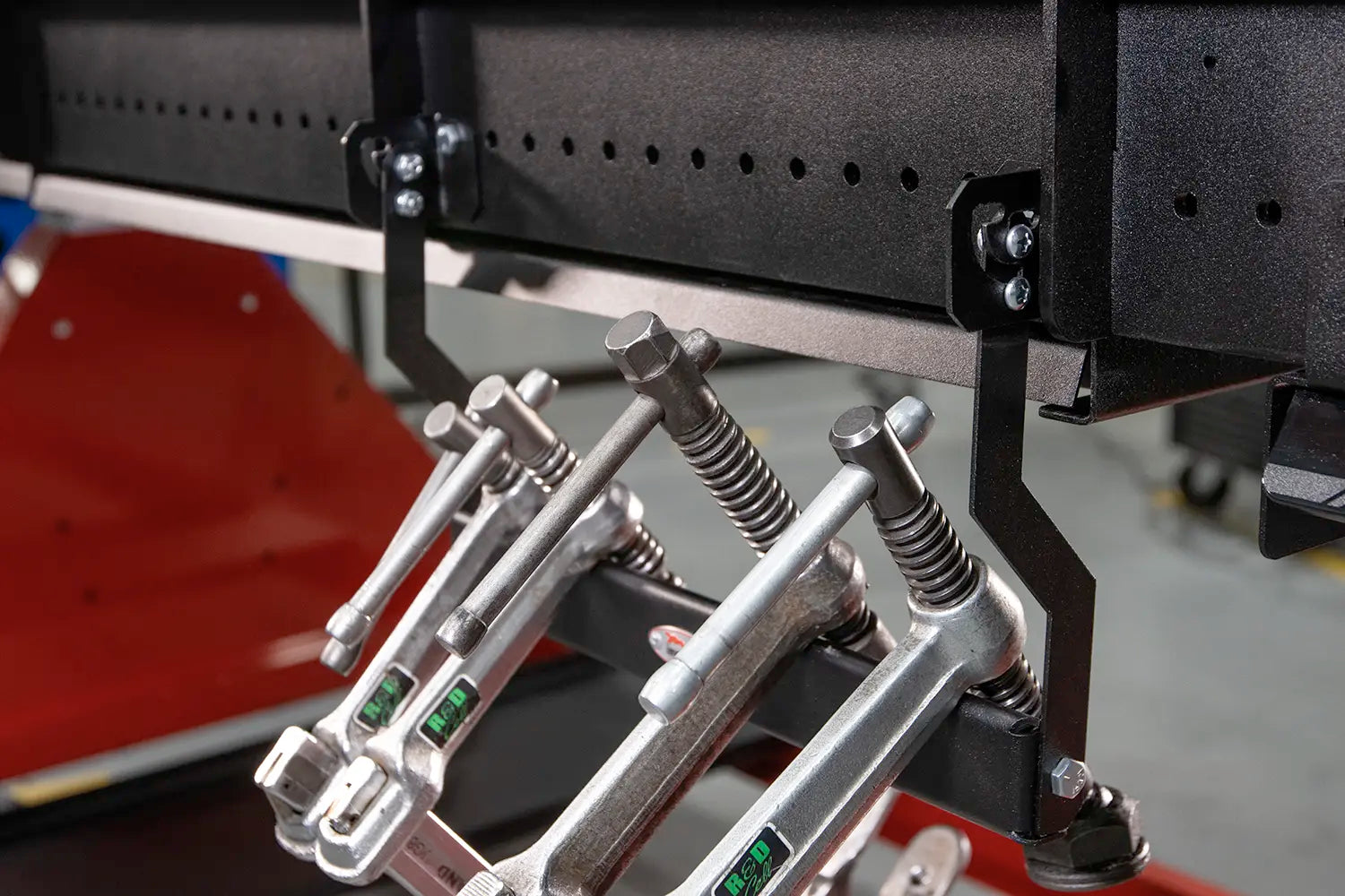 welding clamps hook onto hanger with handles upright