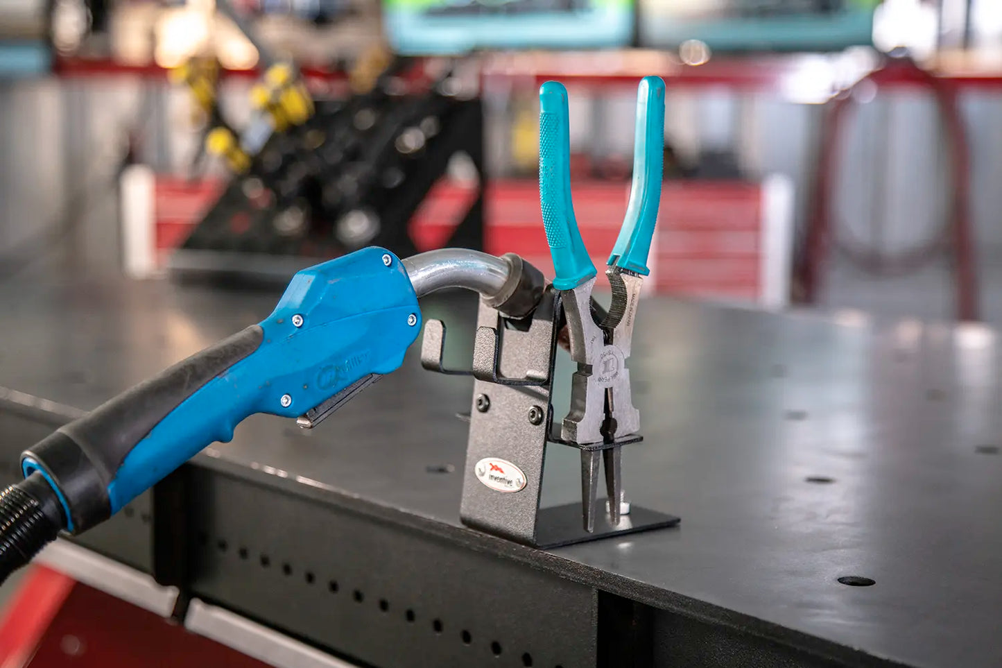 welding pliers mounted along right side of mig torch